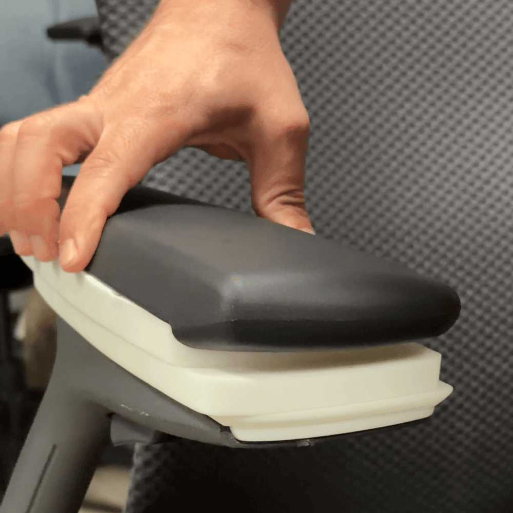 Hand adjusting the 3D arm pad, seen close up