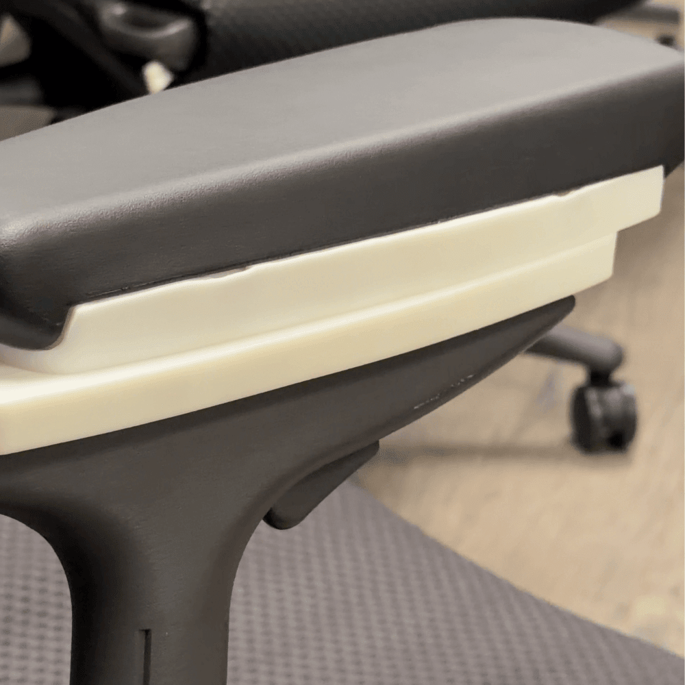 Close-up of the black pad sitting on the white slide-and-pivot base
