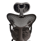 The headrest from behind, its bracket on top of a graphite Mirra 1 back, green background (chair not included)