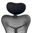 Headrest cushion above the back of a graphite Mirra 1, front view, green background