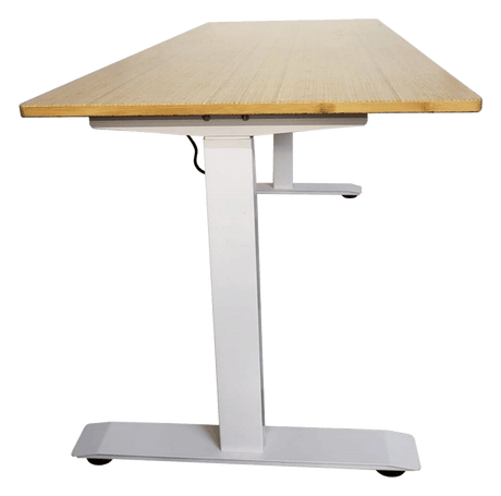 Side view of the standing desk: the bamboo top on a white steel leg and its wide foot